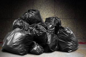 garbage is pile lots dump, many garbage plastic bags black waste at concrete wall, pollution from trash plastic waste garbage, bags bin of plastic waste, pile of garbage waste, lots of junk dump
